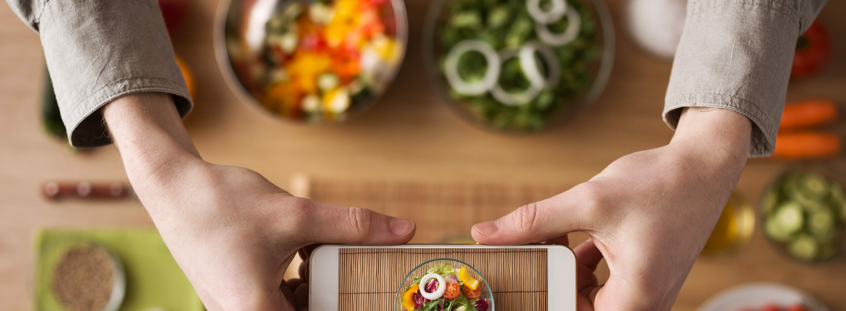 Man,Holding,A,Smart,Phone,Hands,Close,Up,,Kitchen,Table